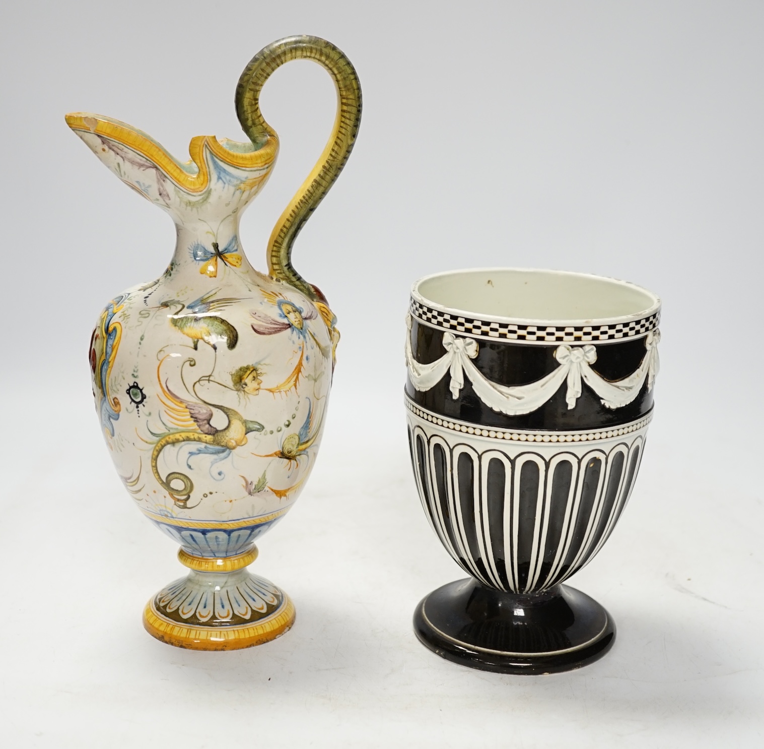 A Wedgwood pot and faience glazed jug and a Cantagalli maiolica pearl glazed jug, 26cm. Condition - poor, losses to upper rim of Cantagalli jug and restoration to base of Wedgwood